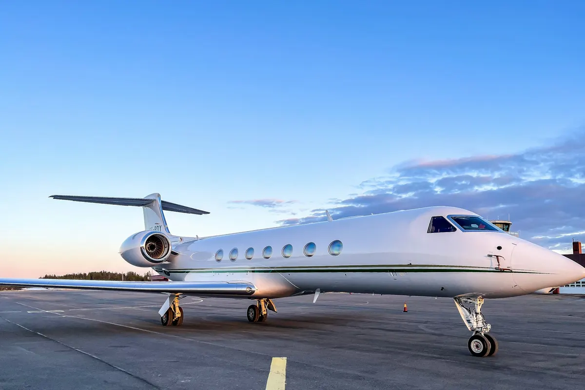 Long-range business jet on the ramp under a clear evening sky